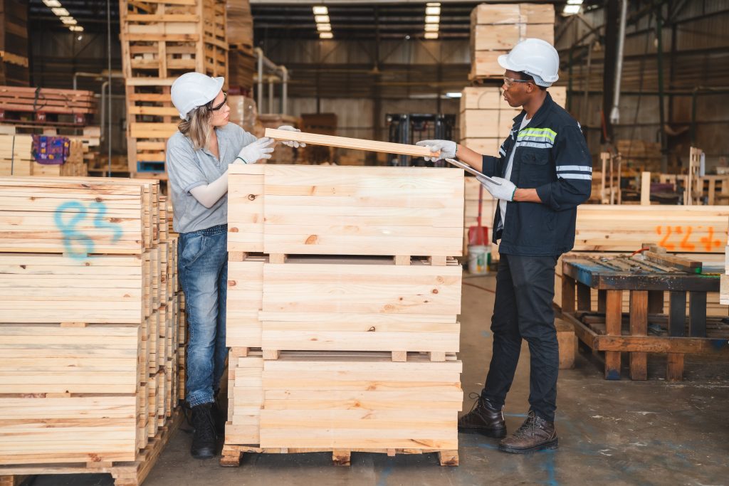 Engineer carpenter worker team checking and inspecting hardwood, timber or wooden pallet material